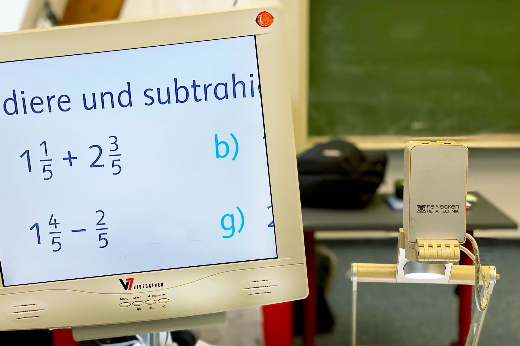 Ein PC steht im Klassenraum und zeigt Bruch-Rechenaufgaben an 